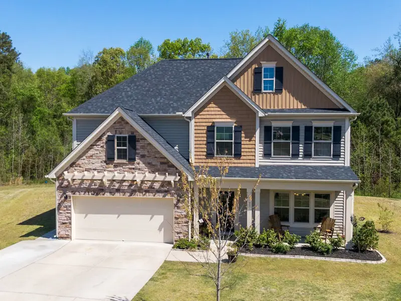 Two-story house in Southampton County, VA with brick and brown siding set on a picturesque lot